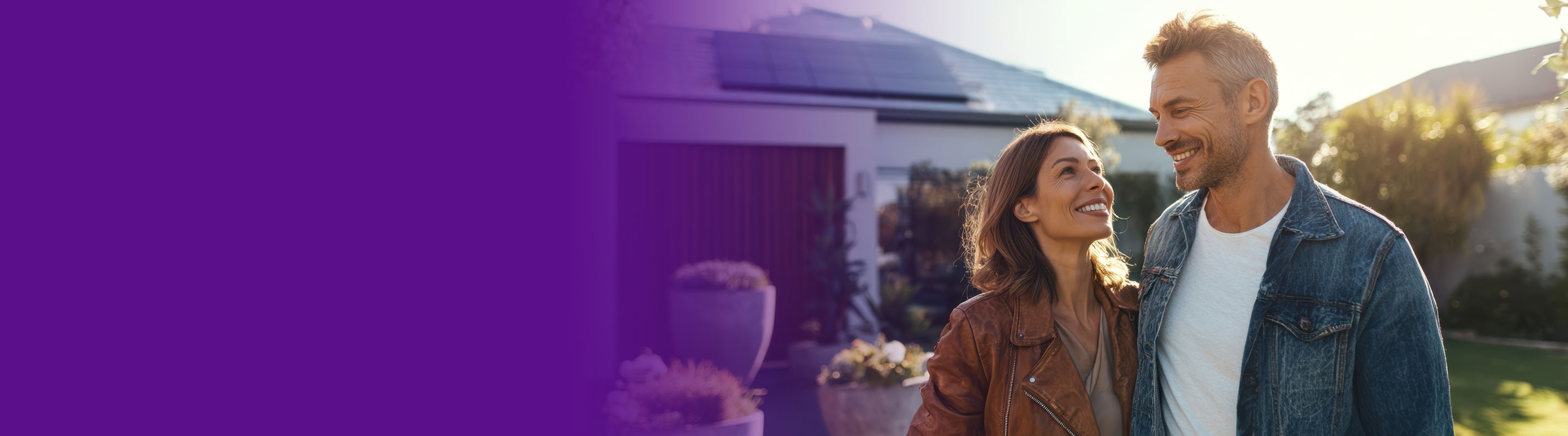 couple looking at each other in front of their remodeled home