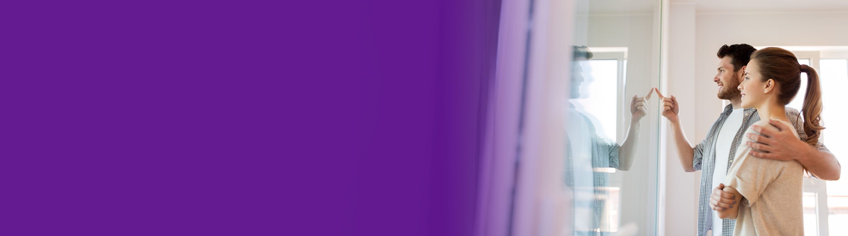 couple looking out their home window