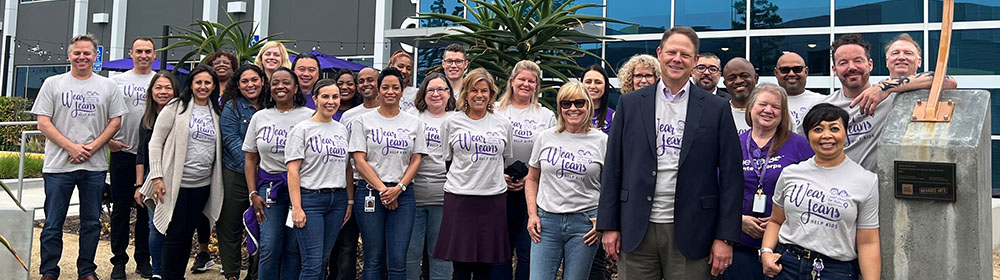 Group of employees pictured in honor of Miracle Jeans Month.