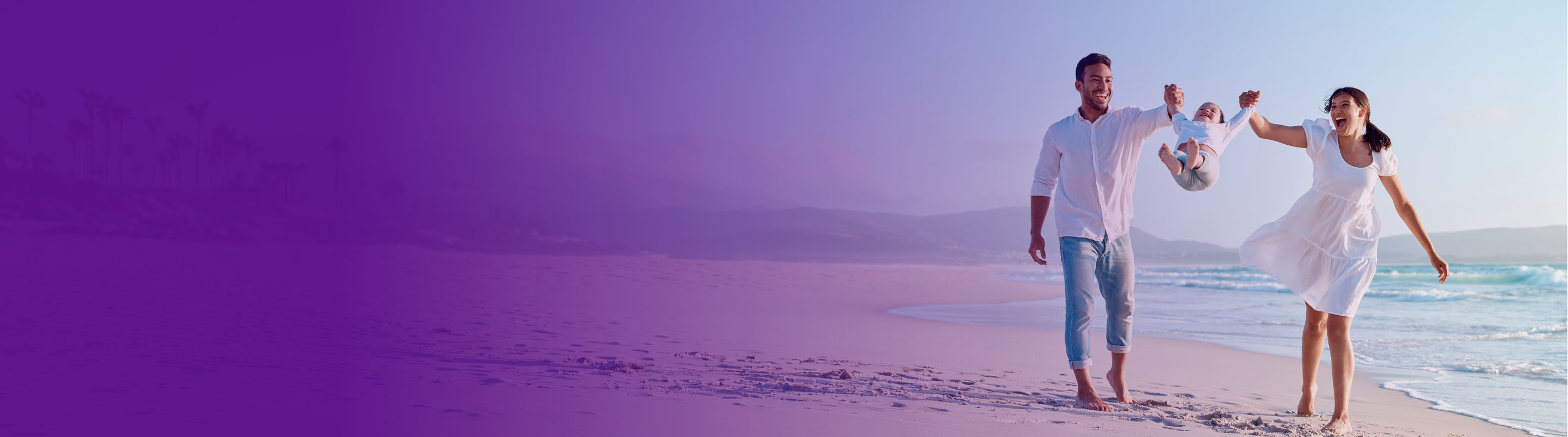 family playing on the beach