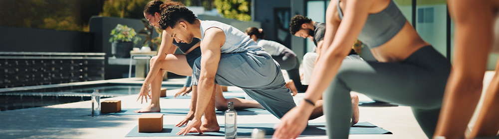 A group of people stretch in a yoga class.