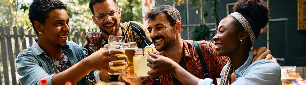 A group of friends celebrate at a restaurant together.