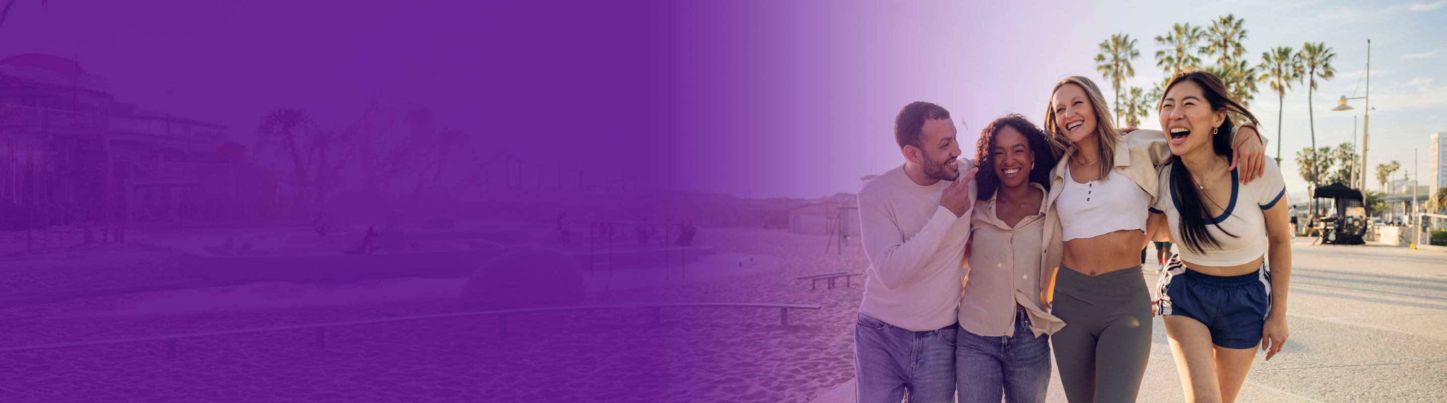 group of friends having a great time on the beach walking