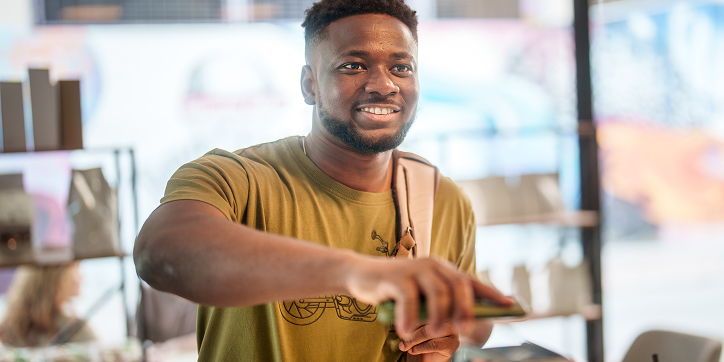Image of a person paying with their mobile wallet