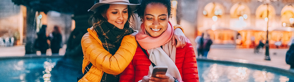 mother daughter viewing mobile phone