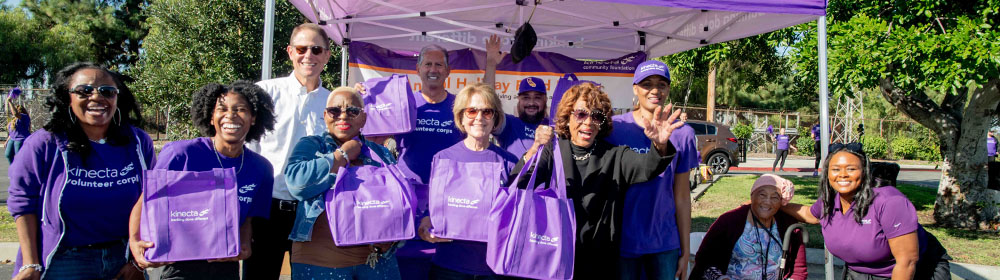Kinecta employees gather at a food drive distribution event.